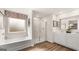 Bathroom with a tub, stand-up shower, double sinks and a decorative mirror at 313 Sound Cir # 140, Stockbridge, GA 30281