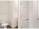 This half bathroom includes a white toilet and a white door leading to another room at 313 Sound Cir # 140, Stockbridge, GA 30281