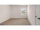 Bright empty bedroom provides neutral carpet and a window to the outside at 313 Sound Cir # 140, Stockbridge, GA 30281