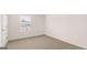 Neutral carpet in an empty bedroom with a window that provides natural light at 313 Sound Cir # 140, Stockbridge, GA 30281