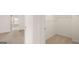 Walk-in closet featuring ample shelving, neutral carpet, and an open doorway for easy access at 313 Sound Cir # 140, Stockbridge, GA 30281