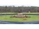 Landscaped community fountain with gazebo in background, with new trees and a circle drive at 313 Sound Cir # 140, Stockbridge, GA 30281