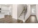 Open-concept entryway featuring a staircase, light wood floors, white walls, and abundant natural light at 313 Sound Cir # 140, Stockbridge, GA 30281