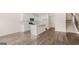 Bright kitchen features white cabinets, stainless appliances, island, and wood-look floors at 313 Sound Cir # 140, Stockbridge, GA 30281