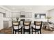 Bright kitchen with a granite countertop island, modern appliances, and stylish bar stools at 313 Sound Cir # 140, Stockbridge, GA 30281