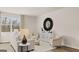 Bright living room with modern decor, neutral tones, wood flooring, and ample seating at 313 Sound Cir # 140, Stockbridge, GA 30281