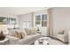 Cozy living room bathed in natural light from expansive windows and adorned with comfortable beige furnishings at 313 Sound Cir # 140, Stockbridge, GA 30281
