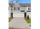 Charming townhome featuring a two-car garage, modern facade, and well-maintained landscaping at 313 Sound Cir # 140, Stockbridge, GA 30281