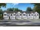 Row of townhomes featuring a two-car garage and well-manicured lawns at 313 Sound Cir # 140, Stockbridge, GA 30281