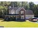 Two-story brick home with a covered porch and attached garage at 245 Mckenzie Dr, Stockbridge, GA 30281