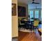 Round glass dining table with green chairs in a well-lit space at 898 Sw Oak Sw St # 3402, Atlanta, GA 30310