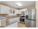 Kitchen featuring stainless steel appliances, granite countertops, and white cabinets at 339 Hiawassee Dr, Woodstock, GA 30188