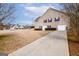 Tan house with three-car garage and driveway at 443 Abbey Pl, Villa Rica, GA 30180