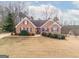 Brick house with landscaped yard and driveway at 443 Abbey Pl, Villa Rica, GA 30180