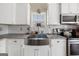 Farmhouse sink and white shaker cabinets in a kitchen at 443 Abbey Pl, Villa Rica, GA 30180