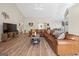 Spacious living room featuring a large leather sectional sofa and hardwood floors at 443 Abbey Pl, Villa Rica, GA 30180