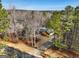 Aerial view of house nestled in wooded area at 55 Rainey Ridge Dr, Oxford, GA 30054