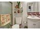 Clean basement bathroom with shower, toilet, vanity, and updated tile at 55 Rainey Ridge Dr, Oxford, GA 30054
