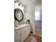 Bathroom featuring a white vanity, large mirror, and pink rug at 55 Rainey Ridge Dr, Oxford, GA 30054