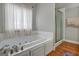 Spa-like bathroom featuring a large jetted tub and separate shower at 55 Rainey Ridge Dr, Oxford, GA 30054