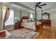 Main bedroom with hardwood floors and a four-poster bed at 55 Rainey Ridge Dr, Oxford, GA 30054