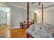 Main bedroom with hardwood floors and four-poster bed at 55 Rainey Ridge Dr, Oxford, GA 30054