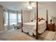 Spacious bedroom with a four-poster bed and bay window at 55 Rainey Ridge Dr, Oxford, GA 30054