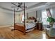 Main bedroom with hardwood floors and a four-poster bed at 55 Rainey Ridge Dr, Oxford, GA 30054