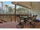 Deck with table, chairs, and wooded views at 55 Rainey Ridge Dr, Oxford, GA 30054