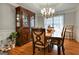 Elegant dining room featuring a large table, chandelier, and hardwood floors at 55 Rainey Ridge Dr, Oxford, GA 30054