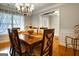Formal dining room with a large table, chandelier, and hardwood floors at 55 Rainey Ridge Dr, Oxford, GA 30054