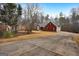Red brick house with a large driveway and mature trees in the front yard at 55 Rainey Ridge Dr, Oxford, GA 30054