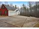 Two-car garage attached to a red brick house with a large driveway at 55 Rainey Ridge Dr, Oxford, GA 30054