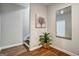 Basement hallway with wood-look flooring, mirror and artwork at 55 Rainey Ridge Dr, Oxford, GA 30054