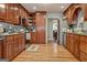 Well-equipped kitchen with wood cabinets, granite countertops, and stainless steel appliances at 55 Rainey Ridge Dr, Oxford, GA 30054