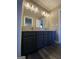 Double vanity bathroom with granite countertop and dark blue cabinets at 70 S Links Dr, Covington, GA 30014