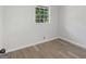 Simple bedroom with large window and wood-look floors at 151 Andover Dr, Jonesboro, GA 30238