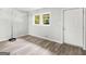 Bright bedroom with gray laminate floors and exterior access at 151 Andover Dr, Jonesboro, GA 30238