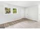 Spacious bedroom with gray laminate floors and two windows at 151 Andover Dr, Jonesboro, GA 30238