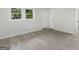 Simple bedroom with gray flooring and a door to the bathroom at 151 Andover Dr, Jonesboro, GA 30238