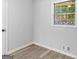 Bright bedroom with window and wood-look floors at 151 Andover Dr, Jonesboro, GA 30238