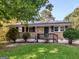 Brick ranch house with a small front porch and well-maintained lawn at 151 Andover Dr, Jonesboro, GA 30238