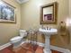 Elegant powder room with pedestal sink and tile floor at 2235 Emerald Dr, Jonesboro, GA 30236