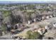 A scenic aerial view captures a cozy neighborhood with mature trees enhancing the appeal of each well-maintained home at 2671 Eastmont Trl, Snellville, GA 30039