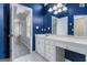 Bathroom with white vanity, blue walls, and tile flooring at 2671 Eastmont Trl, Snellville, GA 30039