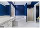 Bathroom featuring corner tub, shower, and blue walls at 2671 Eastmont Trl, Snellville, GA 30039