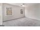 Simple bedroom with carpet, ceiling fan, and two windows at 2671 Eastmont Trl, Snellville, GA 30039