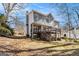 Two-story home with a back deck, stairs, and wooded backyard at 2671 Eastmont Trl, Snellville, GA 30039