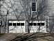 Two-car garage with white doors and gray siding at 2671 Eastmont Trl, Snellville, GA 30039