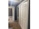 Hallway with gray walls and white closet doors at 1178 King Rd, Riverdale, GA 30296